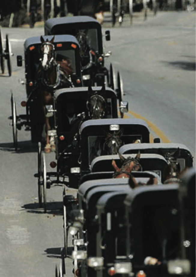 A funeral procession of horse and buggies during the funeral of victim Naomi Rose Ebersole on October 5th, 2006 Credit: Getty Images/Chris Hondros. Image courtesy of CBS News. title=